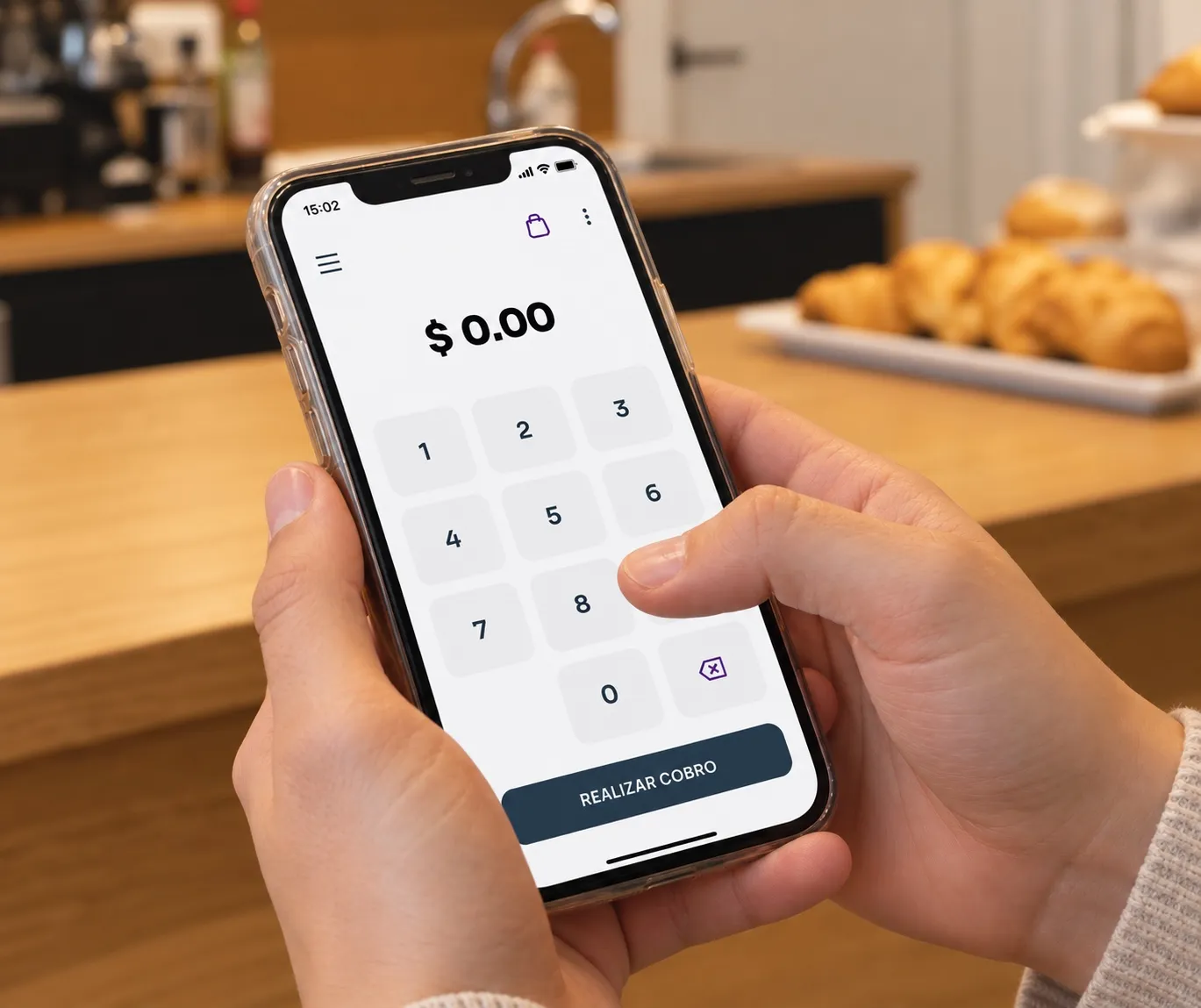 Celular con la app de Cubo lista para cobrar en una cafetería
